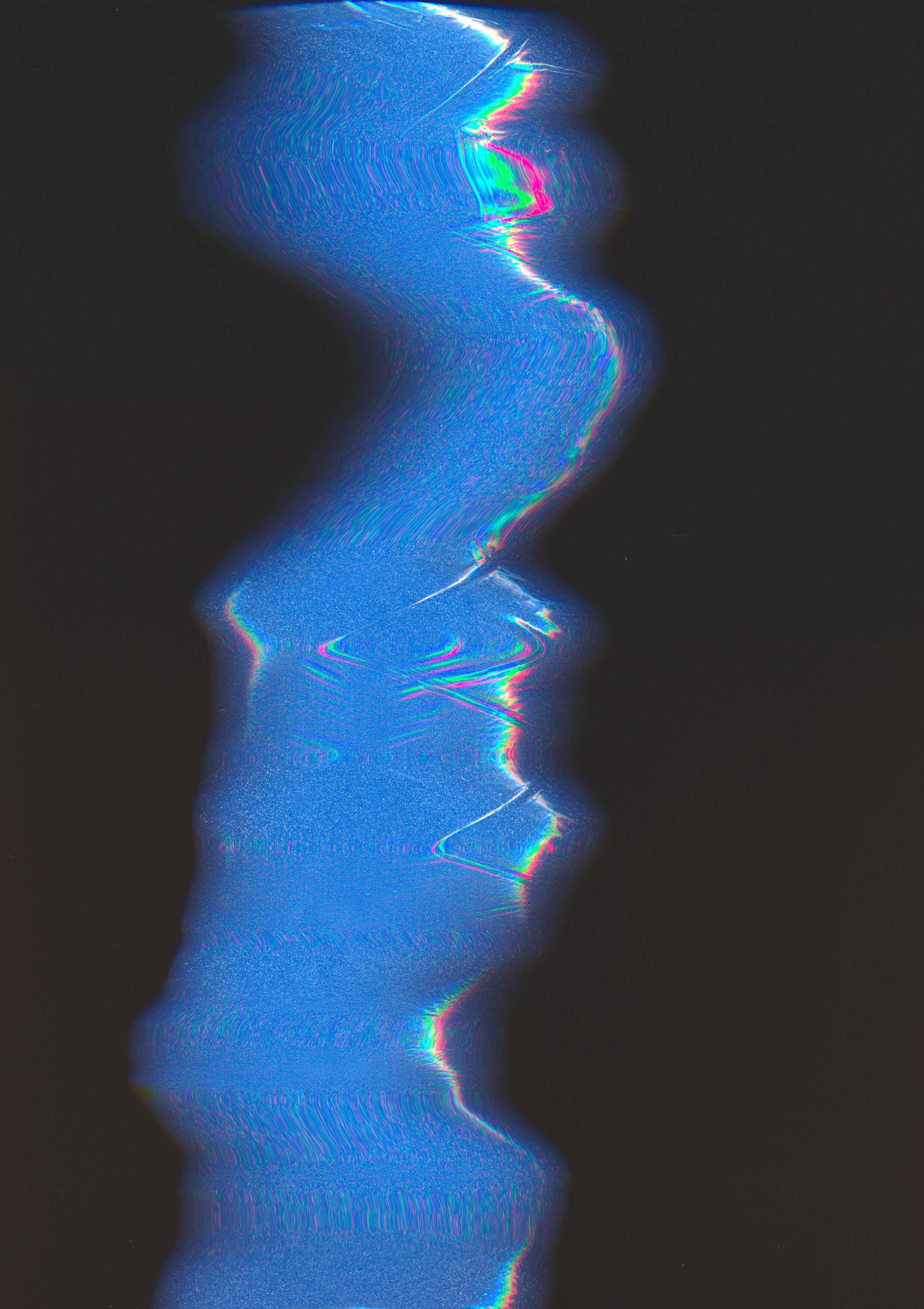 Blue oil-slick looking photocopy of foam, on a black background